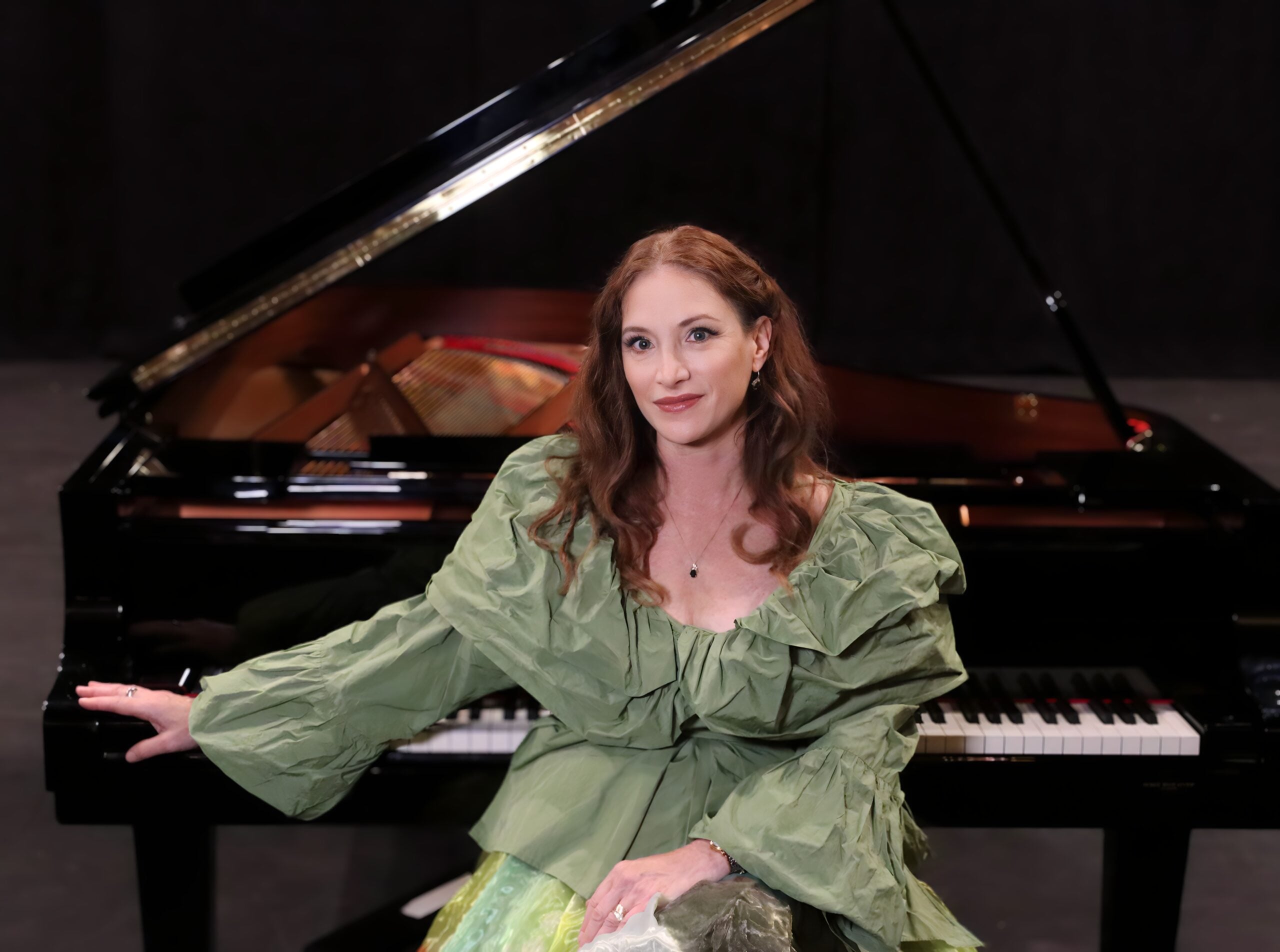 ROBIN SPIELBERG GREEN seated at piano